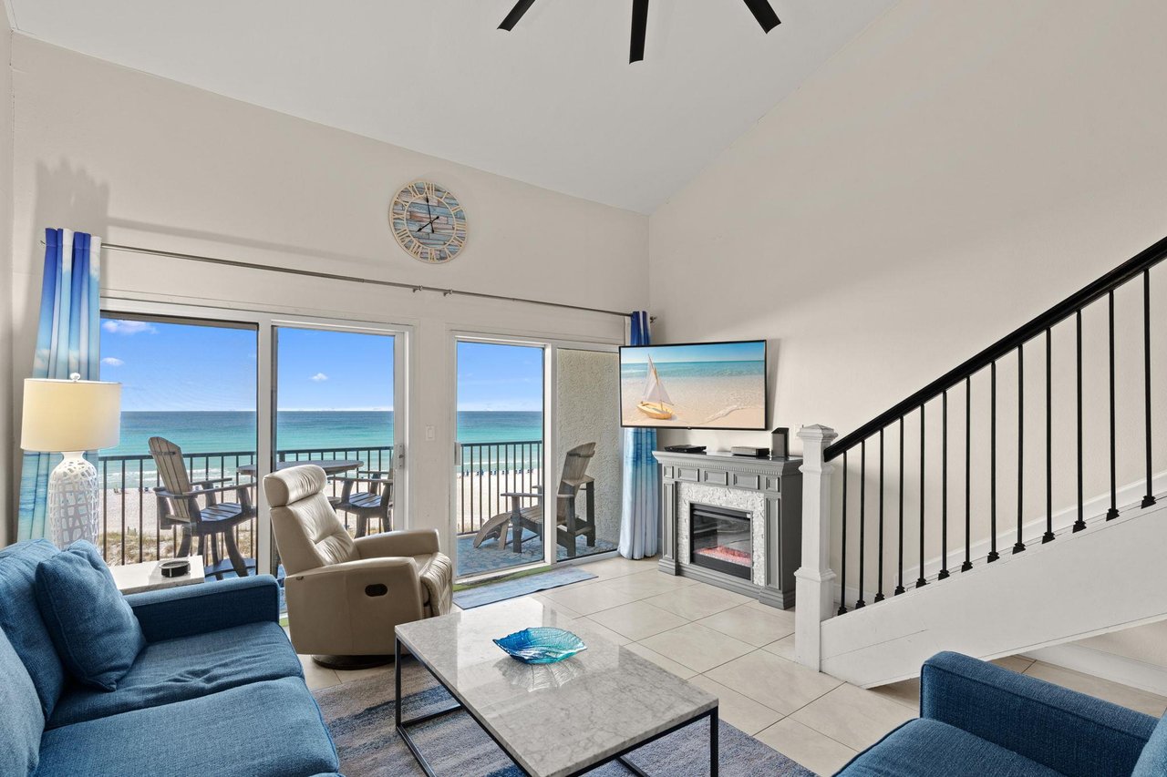 Unwind in your oceanfront living space where panoramic views greet you through expansive glass doors. Relax on plush sofas or step onto the private balcony to feel the coastal breeze.
