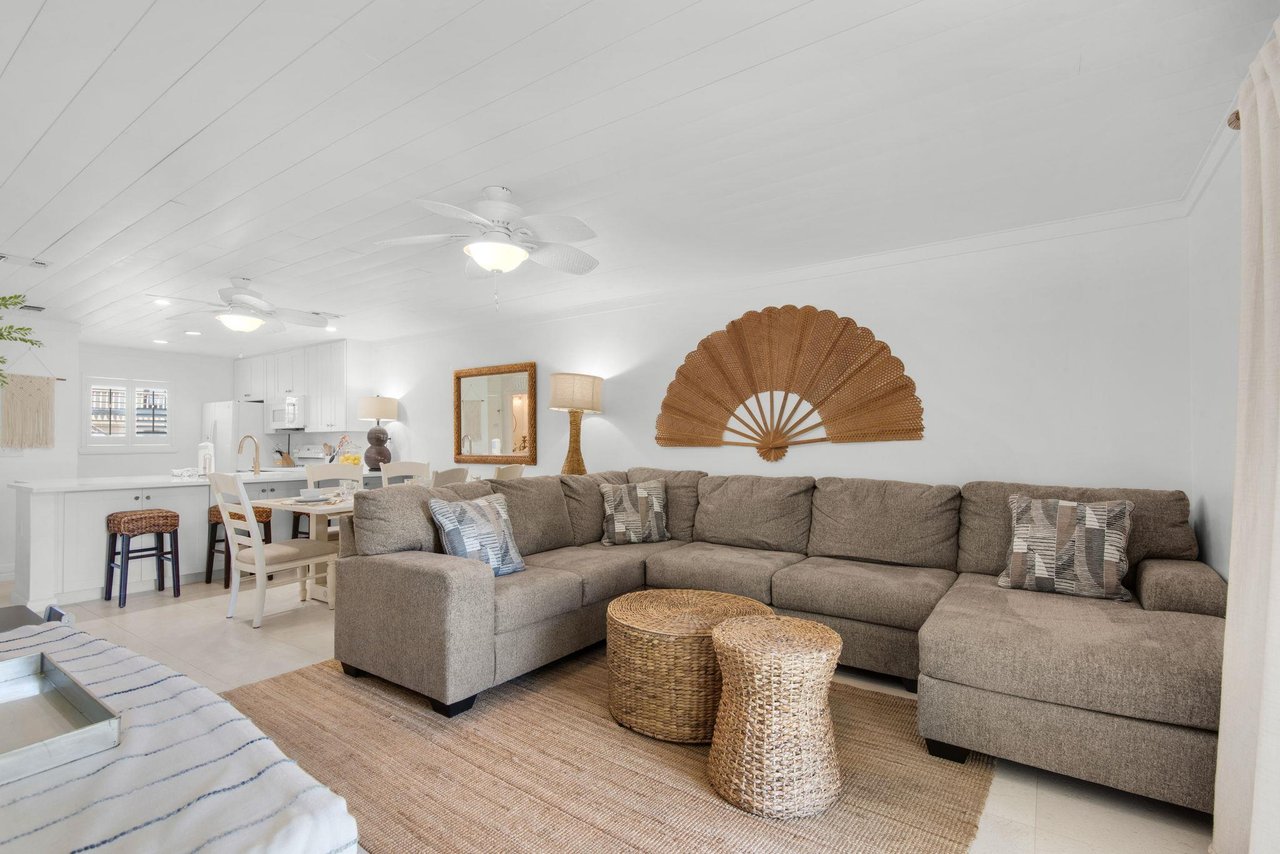 Sink into plush sofas in this airy openplan space where soft coastal tones and natural textures create your serene home base. The fullyequipped kitchen flows seamlessly into your living area for eff