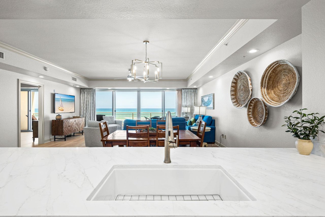 This bright, open living space invites you to unwind with stunning views stretching across the horizon from your balcony.