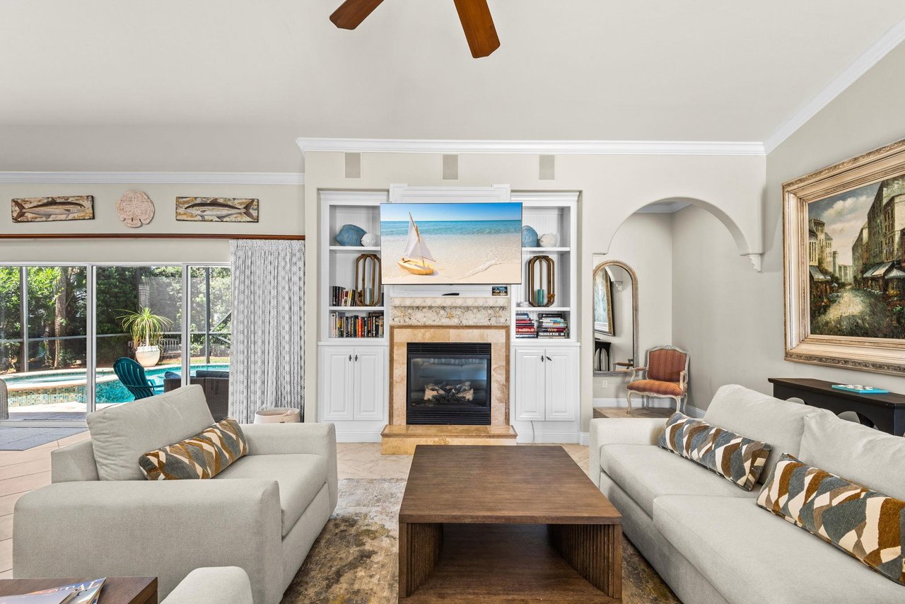 Settle into the bright living room, where beachy artwork and a cozy fireplace set the scene