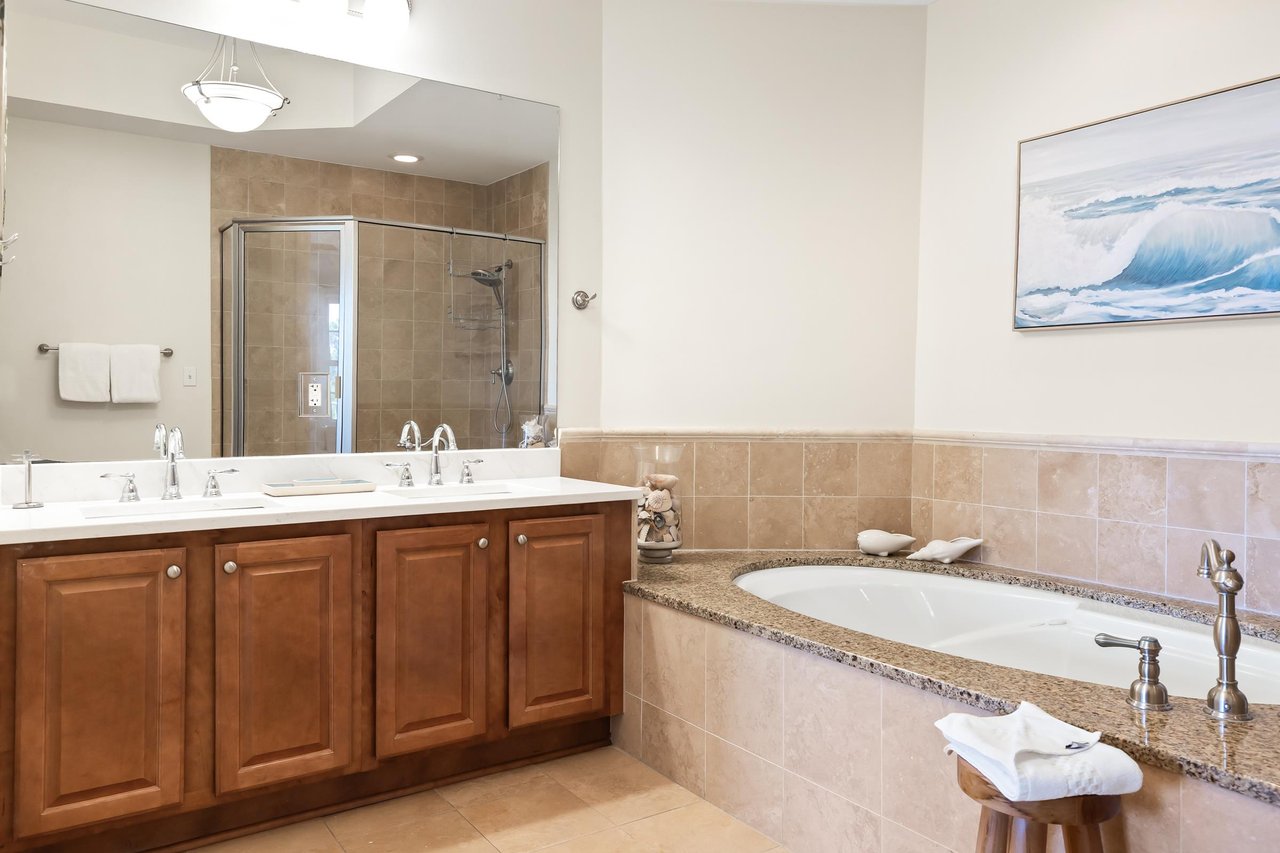 Unwind in your spainspired bathroom with dual sinks, a walkin shower, and a soaking tub framed by warm granite—a perfect retreat after exploring the coast.