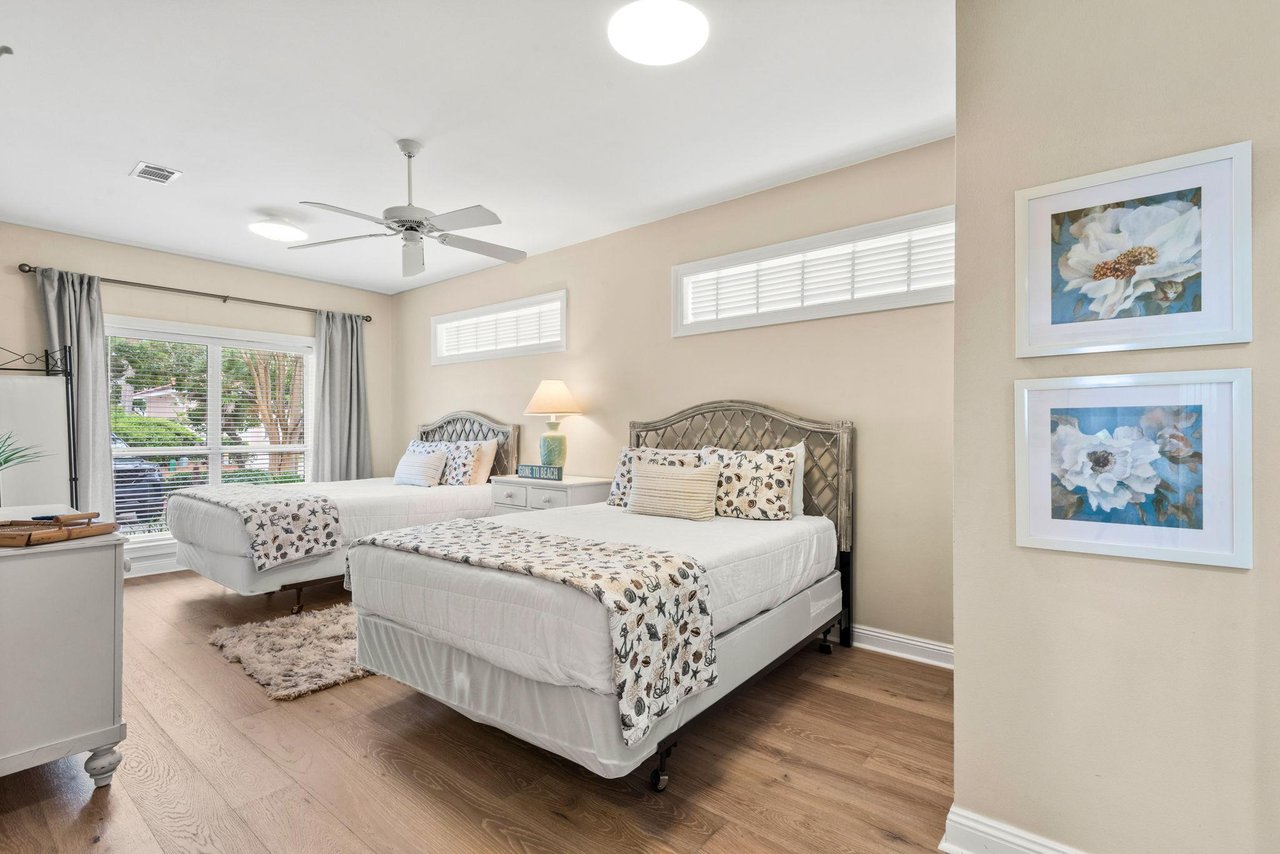 This spacious bedroom features two queen beds and a calming palette that invites deep rest after a day of adventure.