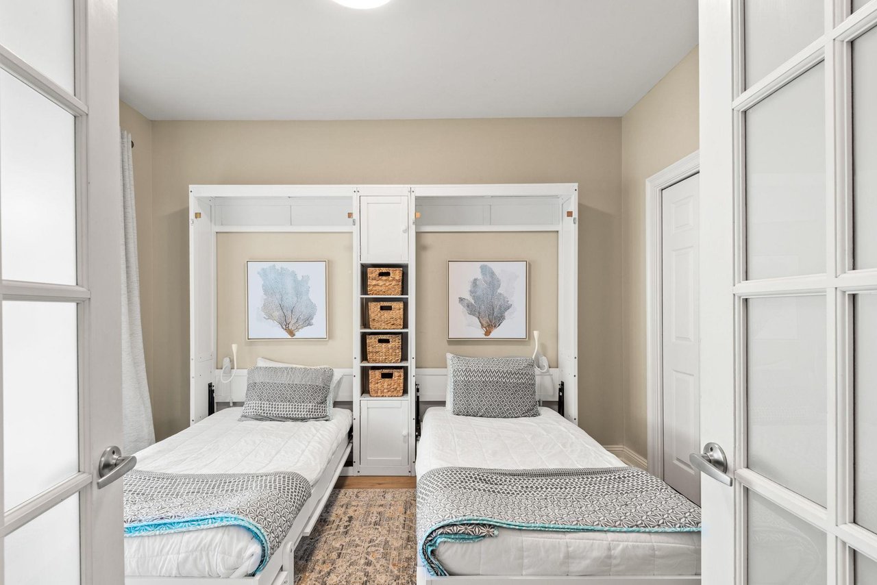 This perfectly appointed bedroom coastal artwork and a smart Murphy bed system—maximizing space without sacrificing style or comfort.