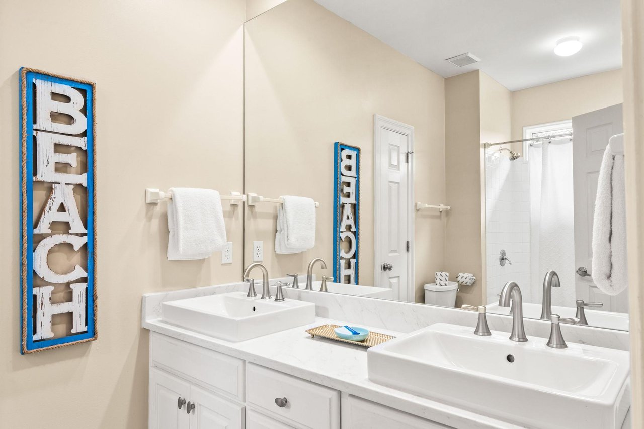 Start your day with ease in this spacious bathroom, featuring a double vanity, elegant countertops, and ample space to get ready in comfort.