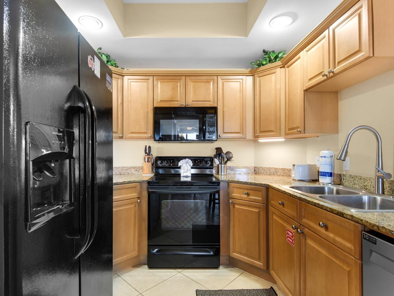 The fully equipped kitchen features modern appliances and granite countertops