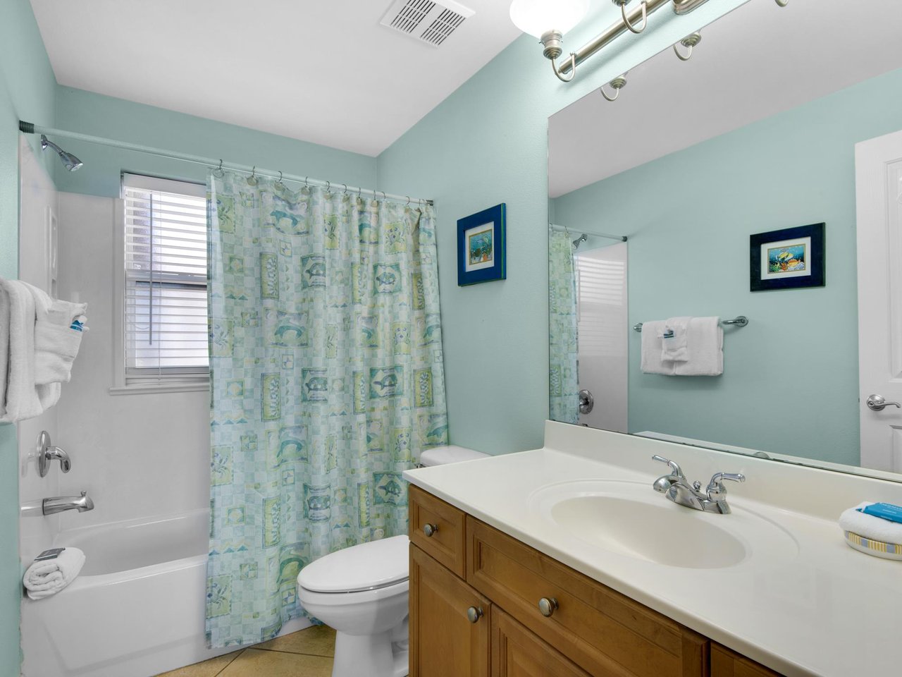 The guest bathroom features a full tubshower, and fresh towels.