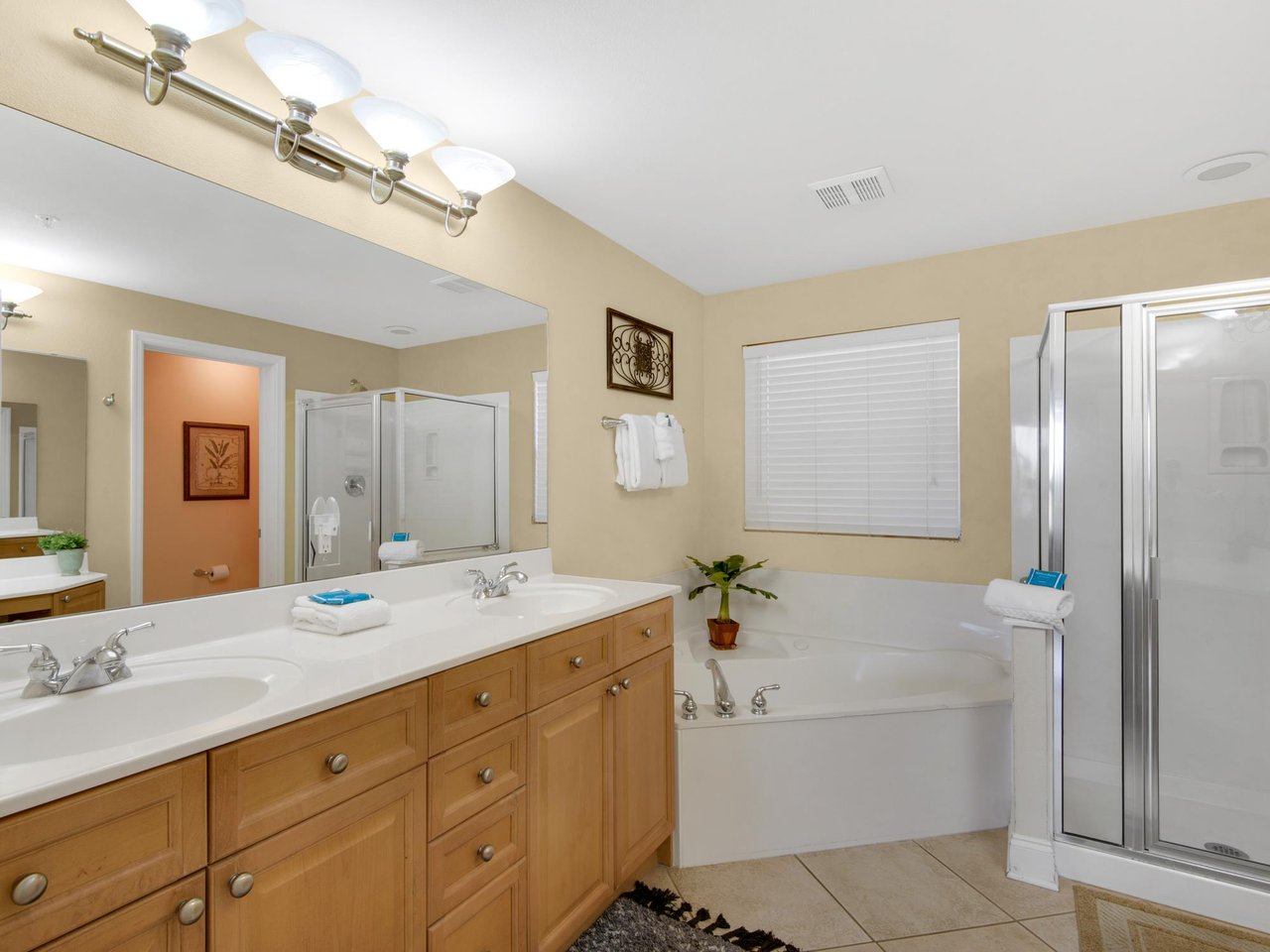 The primary bathroom retreat features a spacious soaking tub, dual vanities and a separate glassenclosed shower.