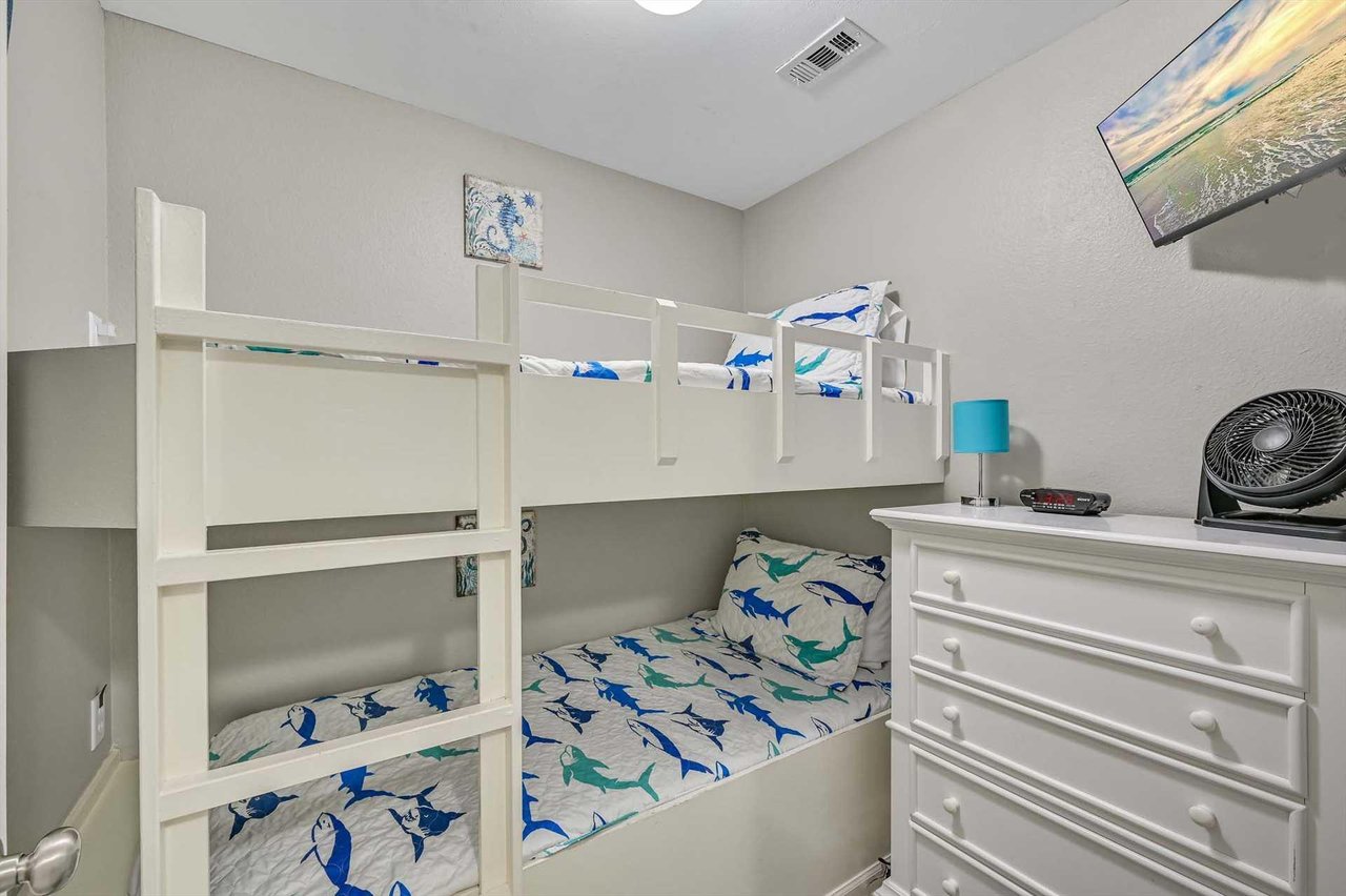 This cozy bunk room gives the kids their own cheerful space, with playful bedding and plenty of storage to keep things organized during your beach getaway.