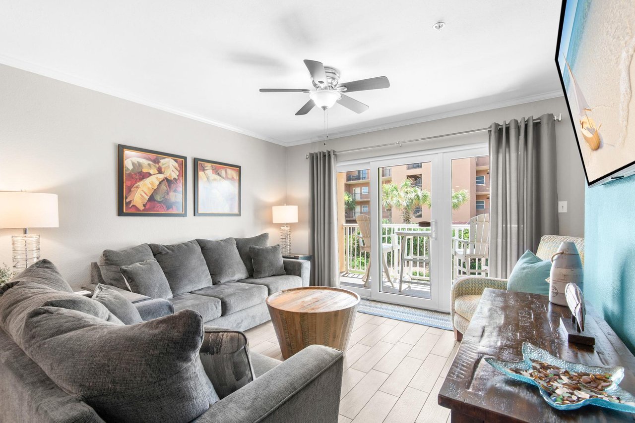 Enjoy your bright, airy living room, where a private balcony invites you to soak in the sunshine and fresh air just beyond the glass doors.