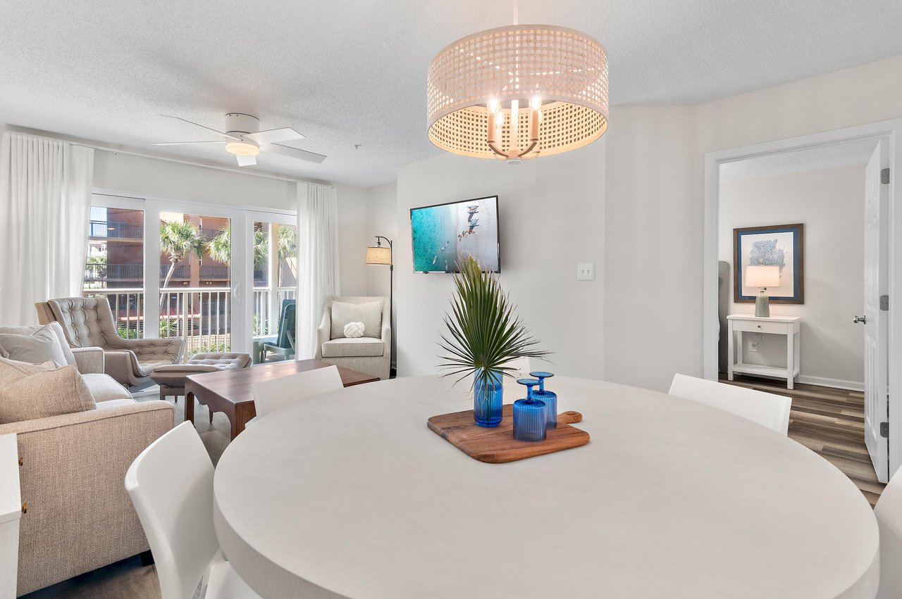 Relax in your openconcept living and dining area, where natural light floods through wide windows and coastalinspired décor sets the tone for a breezy escape.