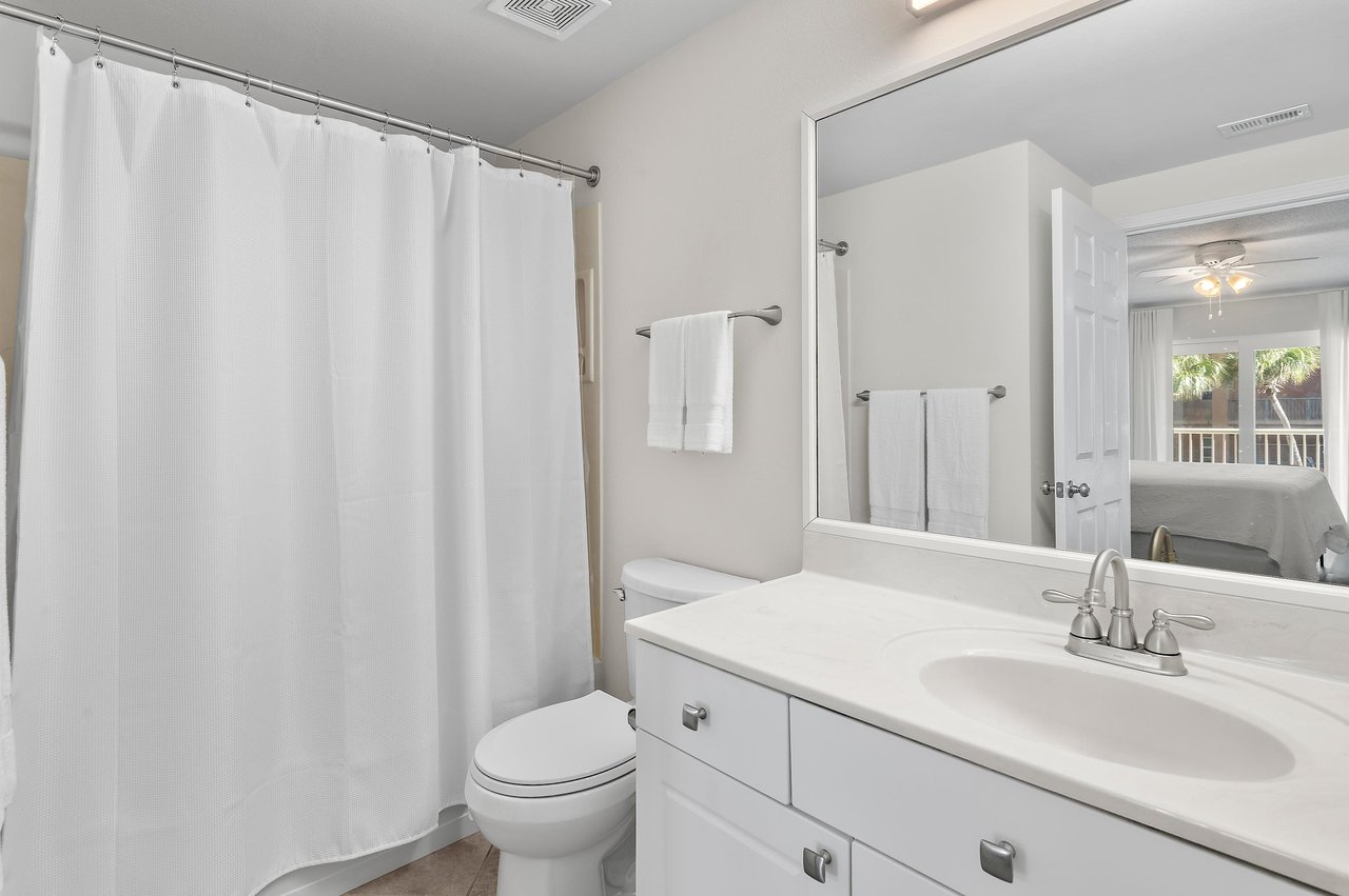 Step into your private Primary bath featuring fresh linens, a full vanity, and a relaxing shower to refresh after a day of exploring.