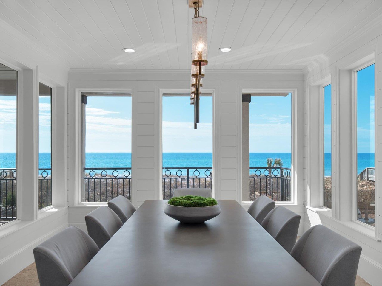 2269500 A Dining Room Table With A Large Window Overlooking The Ocean
