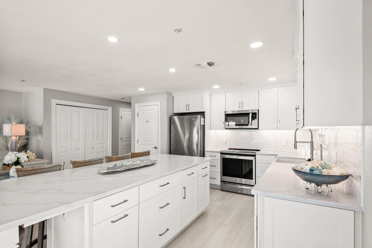 Your modern kitchen is designed for easy meal prep, with sleek white cabinetry and stainless appliances