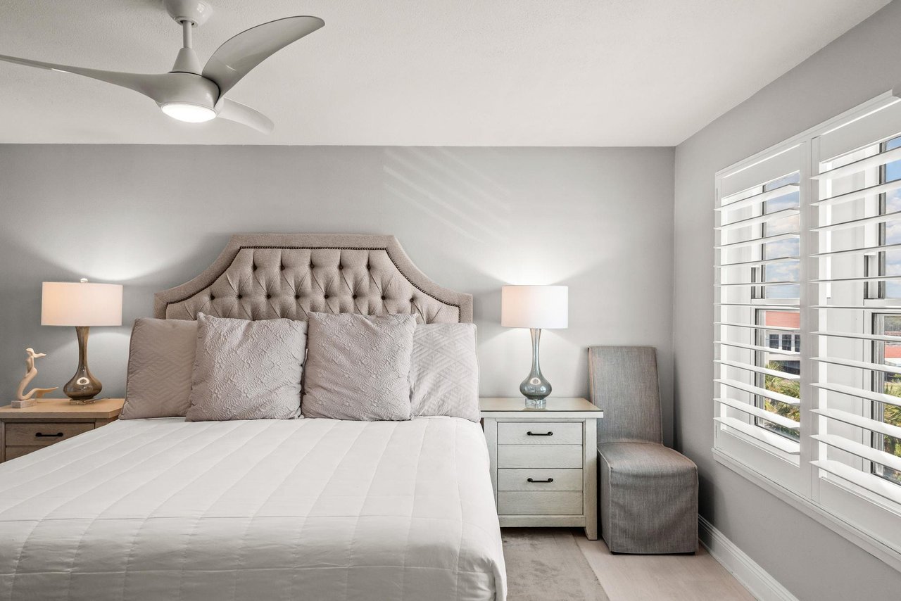 Unwind in this serene bedroom with plush bedding and elegant tufted headboard.