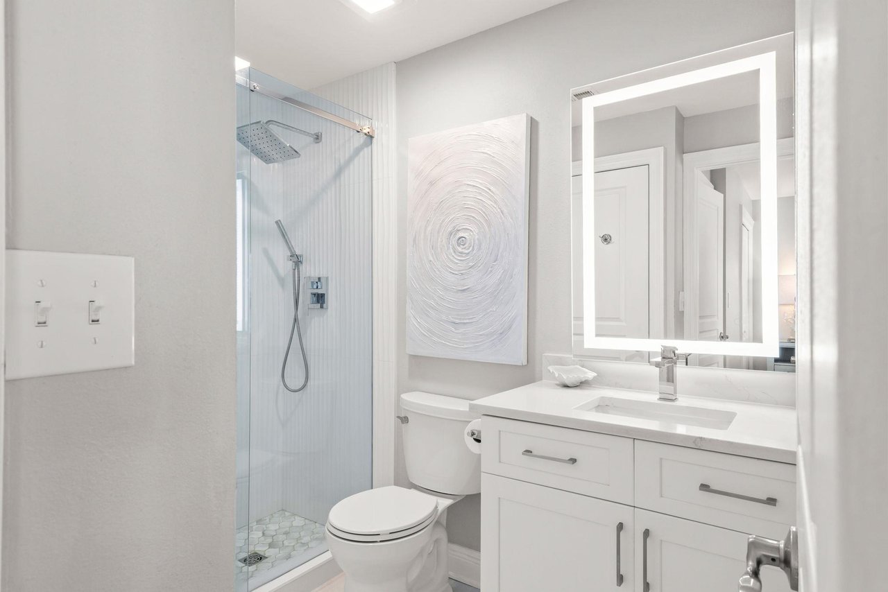 Bathroom 2 with a walkin glass shower and modern finishes.