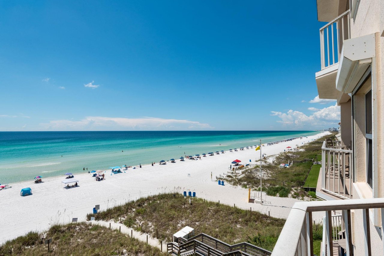 White sands and turquoise waters stretch endlessly before your private balcony, where soft ocean breezes and the sound of gentle waves invite your perfect beach escape.