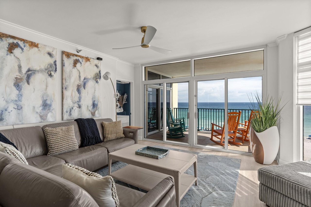 Sink into this inviting living room where coastal elegance meets comfort, and step onto your private balcony to soak in stunning ocean views stretching to the horizon.