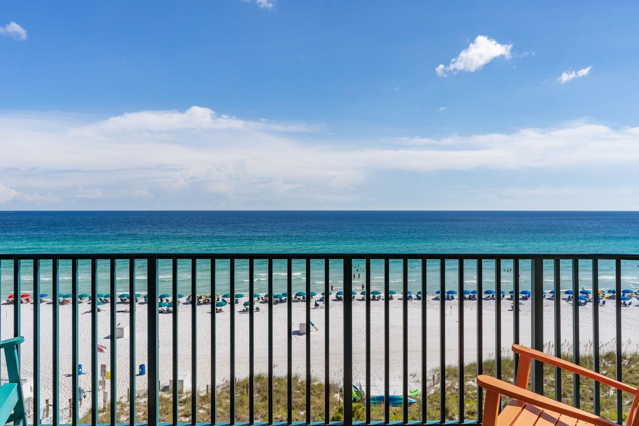 The pristine white sand beach and emerald gulf waters stretch endlessly beyond your private balcony. Watch the beachgoers relax under colorful umbrellas while you unwind in your own openair retreat.