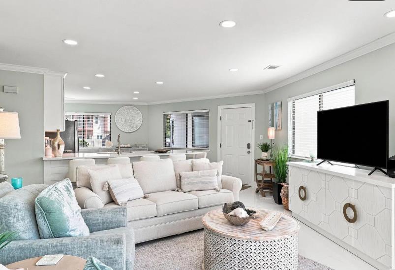 Settle into this airy, sunlit living space, where soft neutrals and coastal accents invite you to unwind.