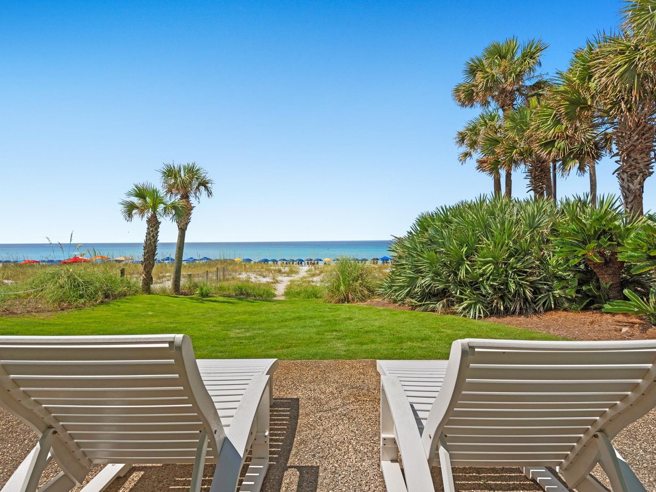 lush green lawn leading to the beach