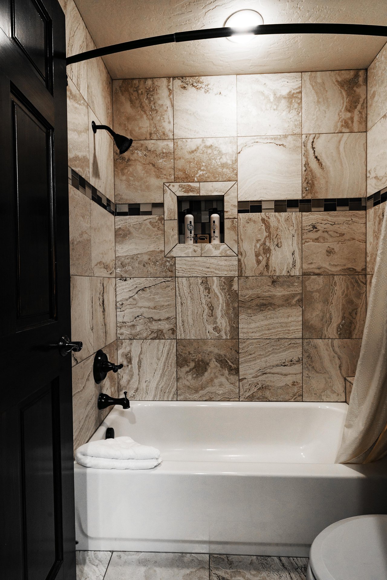Showertub combo in the full guest bathroom with tile work
