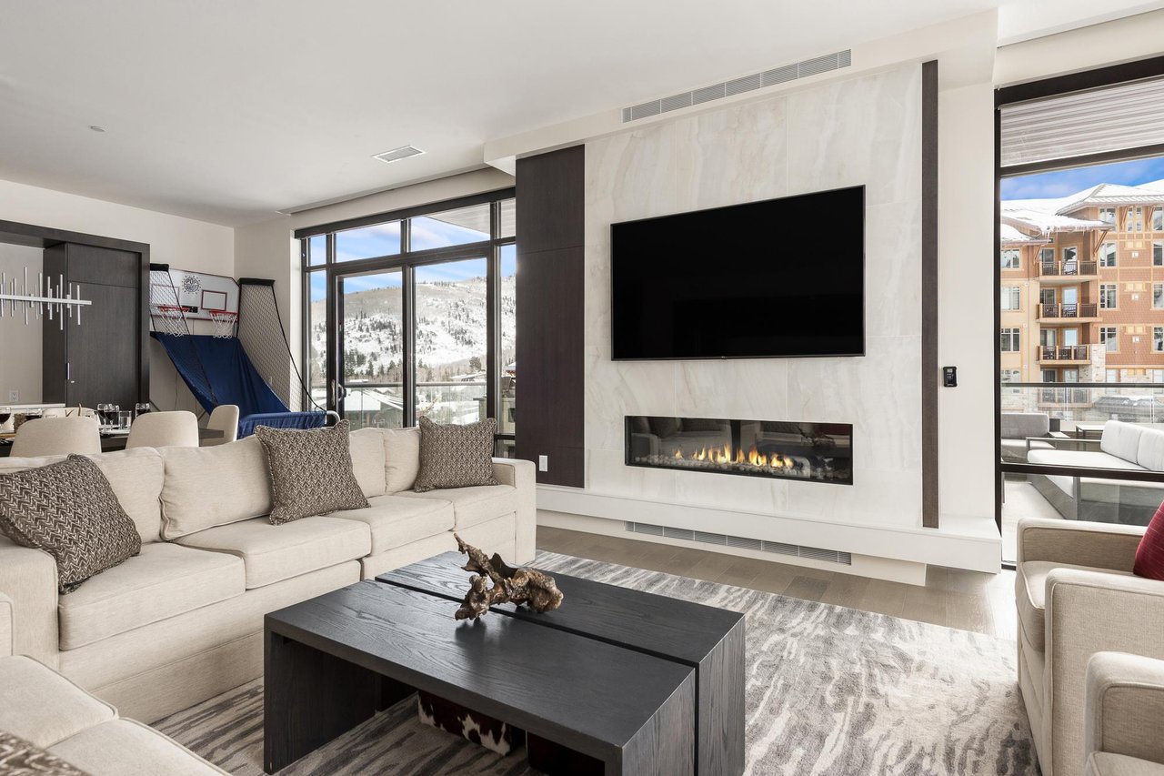 Living room with private patio access and head to head basketball shootout game for kids and adults alike