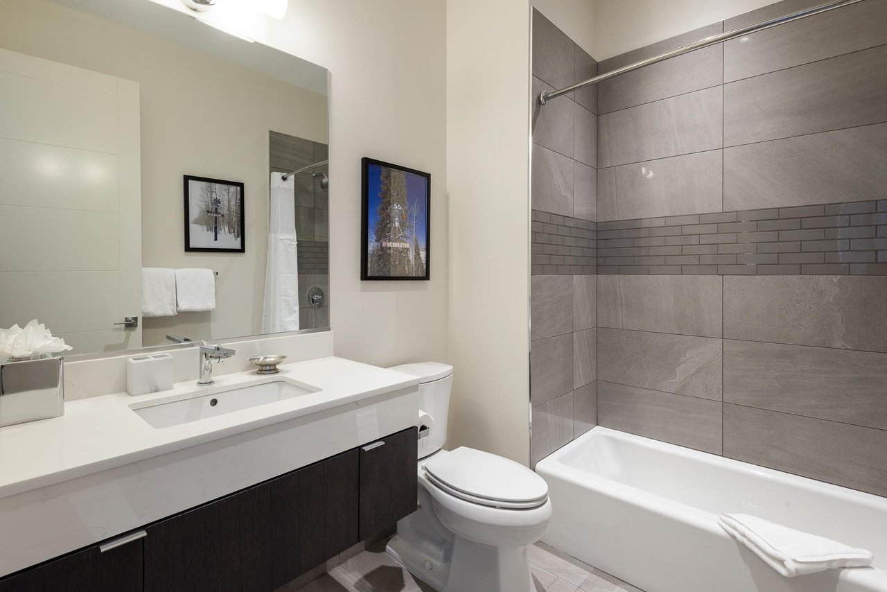 Ensuite full bathroom for the bunk room with shower tub combo
