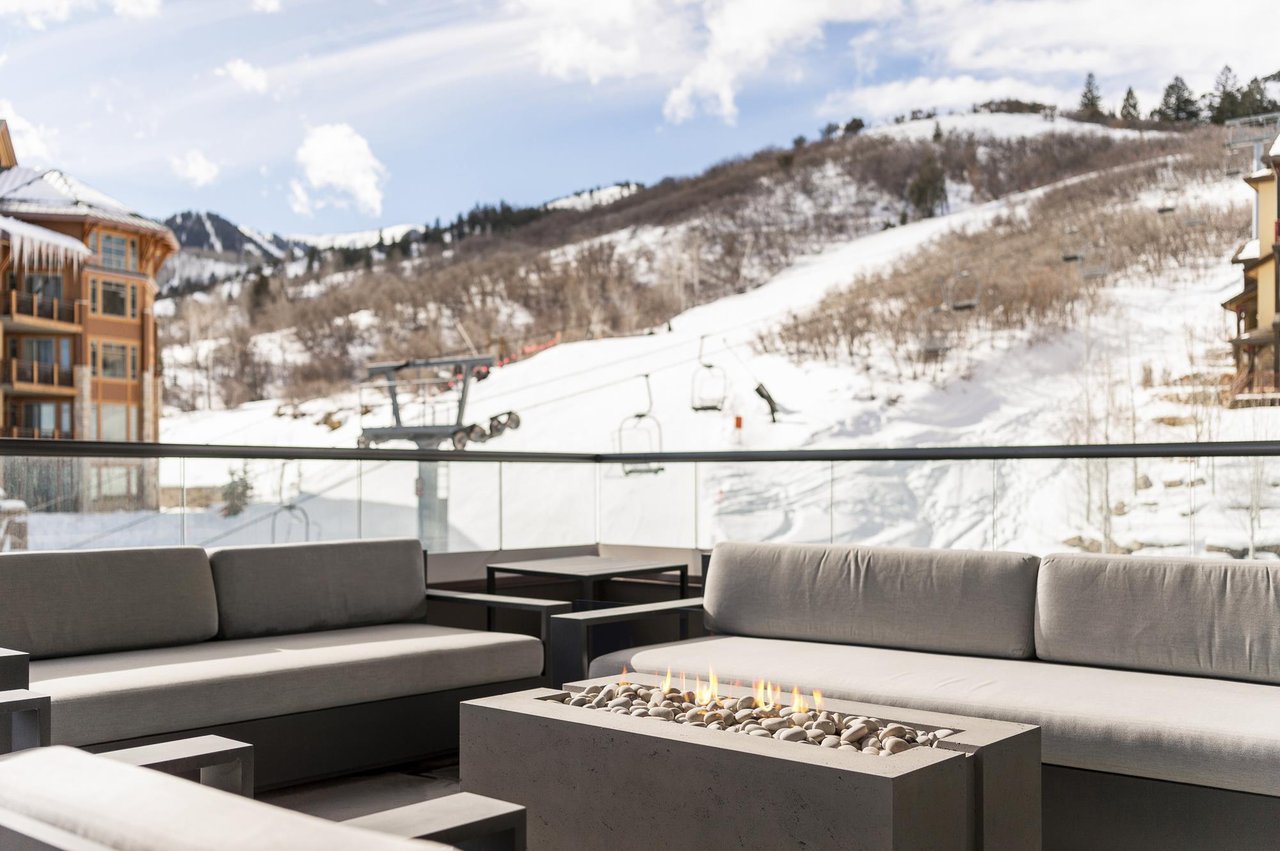 Gas fireplace and lounge area on the private patio with stunning mountain views