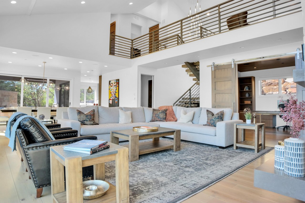 Vacation rental living room with wooden coffee tables and end tables and comfortable seating.