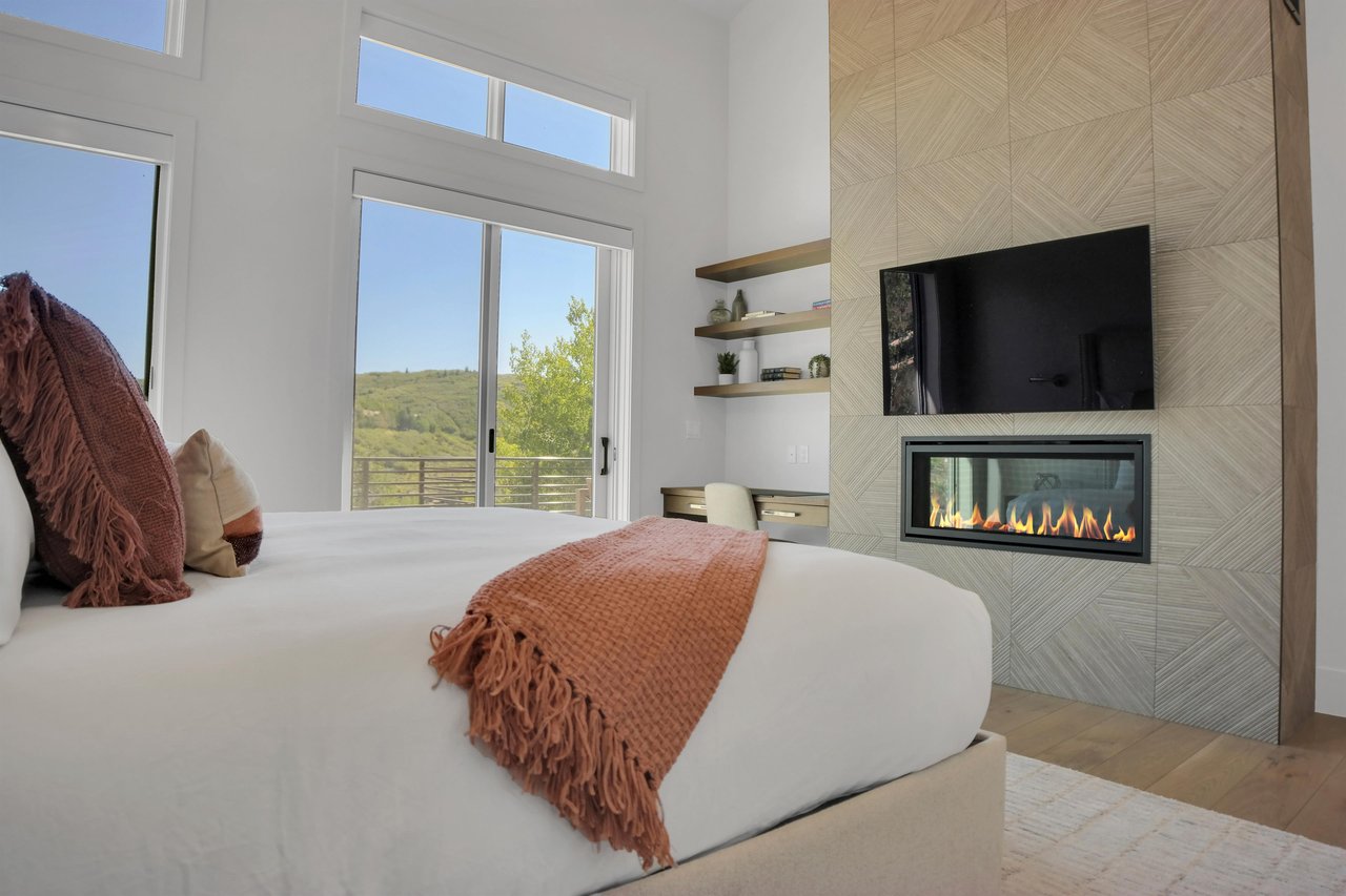 Vacation rental main suite with built in gas fireplace and flat screen TV.