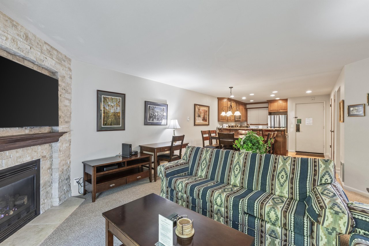 Snow Flower 135s living room with southwestern upholstered couch and the open concept dining room.