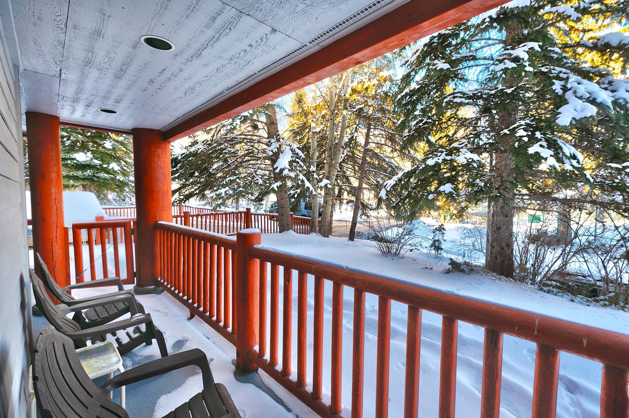 Private patio overlooks pine trees and the tennis courts