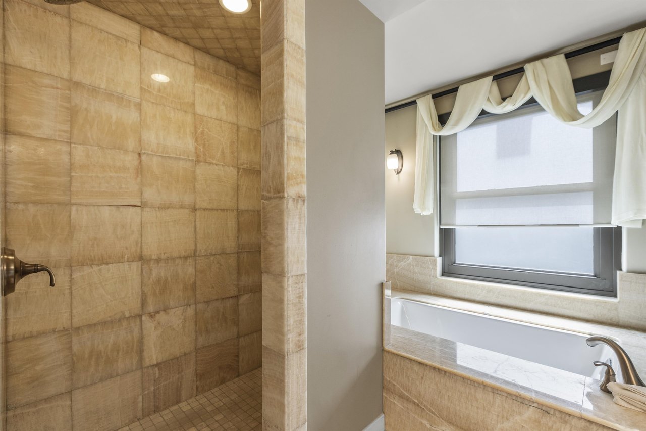 The second bedrooms en suite bathroom has a walk in shower and deep jetted tub.
