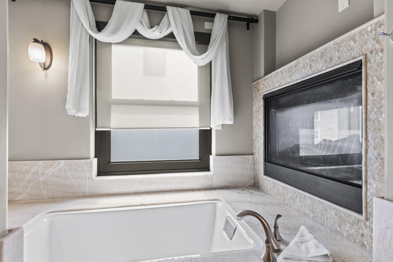 The second bedrooms en suite bathroom has a fireplace above a deep jetted tub.