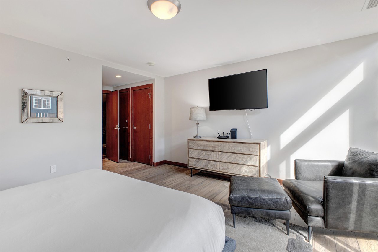 Lowell 402 offers a king size bed in bedroom 2, with a flat screen TV and dresser.