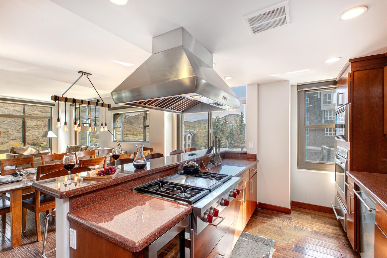 Lowell 402 kitchen island with range and stainless steel range hood.
