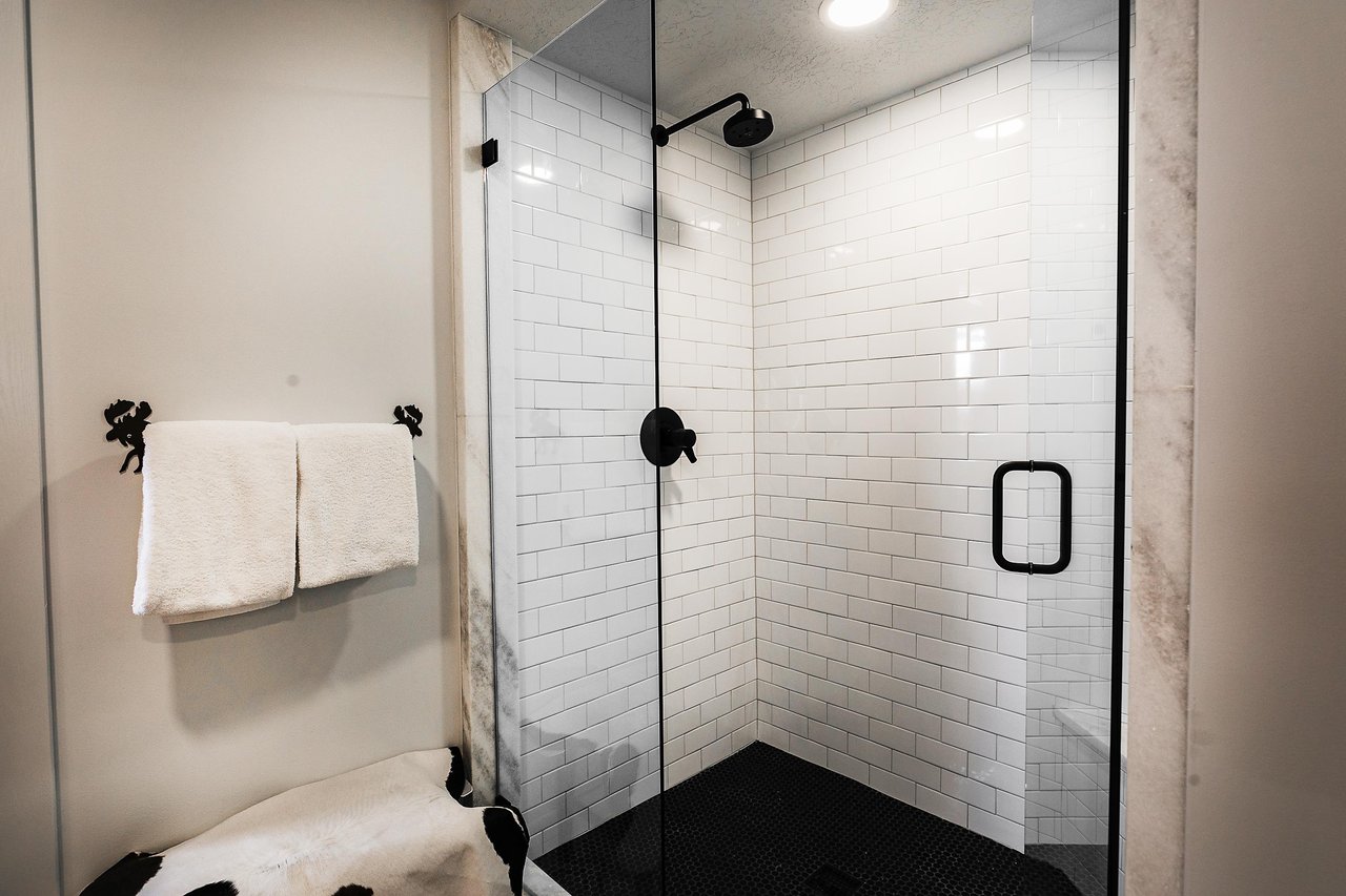 A bathroom with a walkin shower.