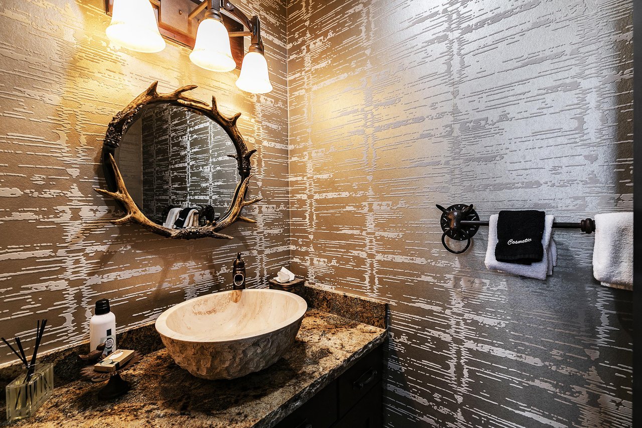 A powder room with antler mirror.