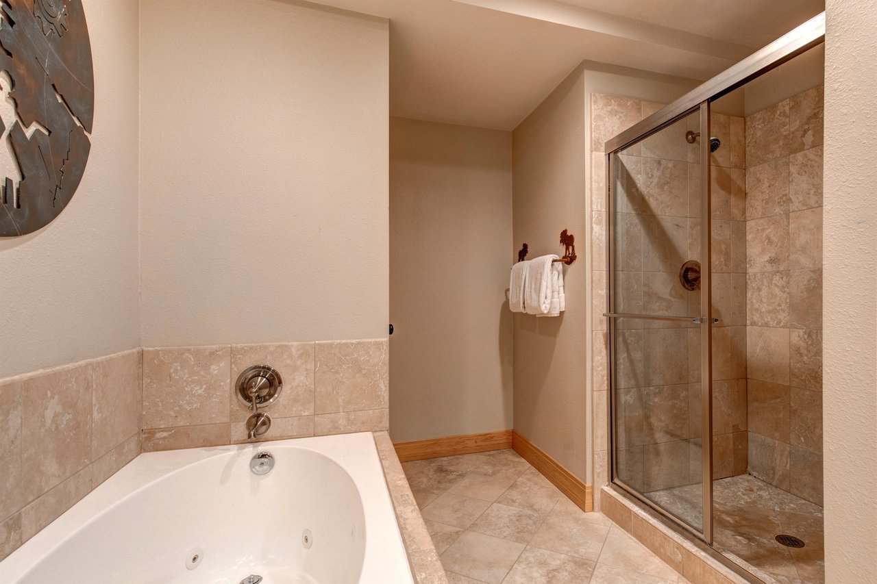 The en suite bathroom has a walkin shower and deep soaker bathtub.