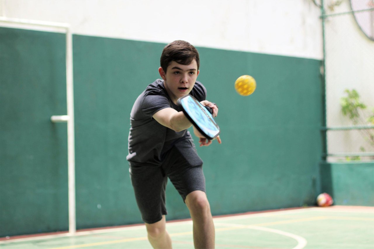 6554403 Boyplayingpickleballindoors