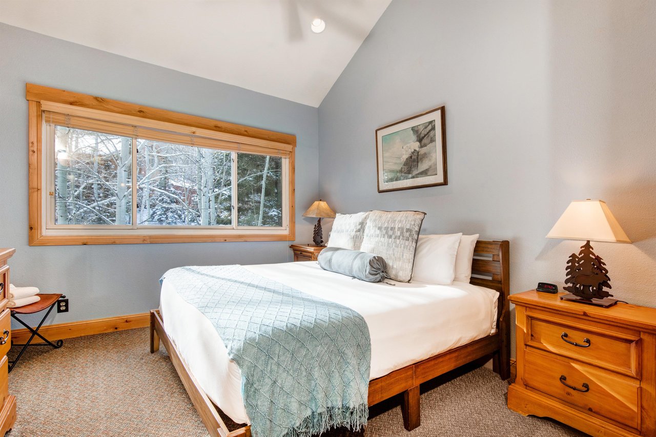 The main suite has a kingsize bed and wooden furniture.