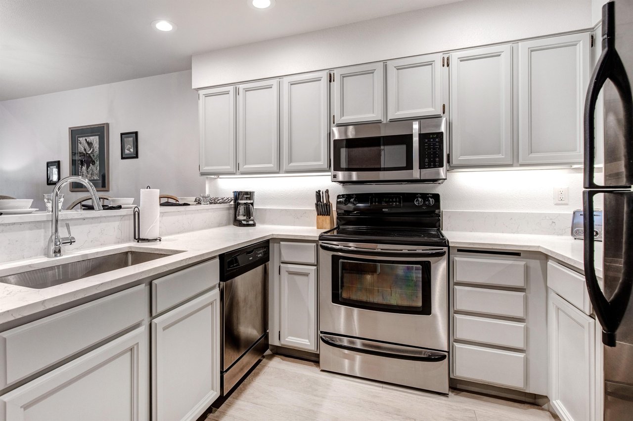 Snow Flower 152 has a well equipped kitchen with grey cabinets and stainless steel appliances.