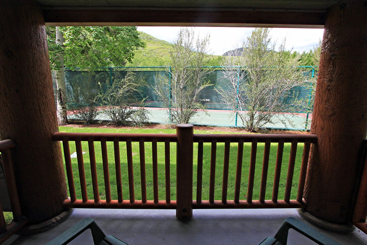 The private patio includes views of the tennis courts
