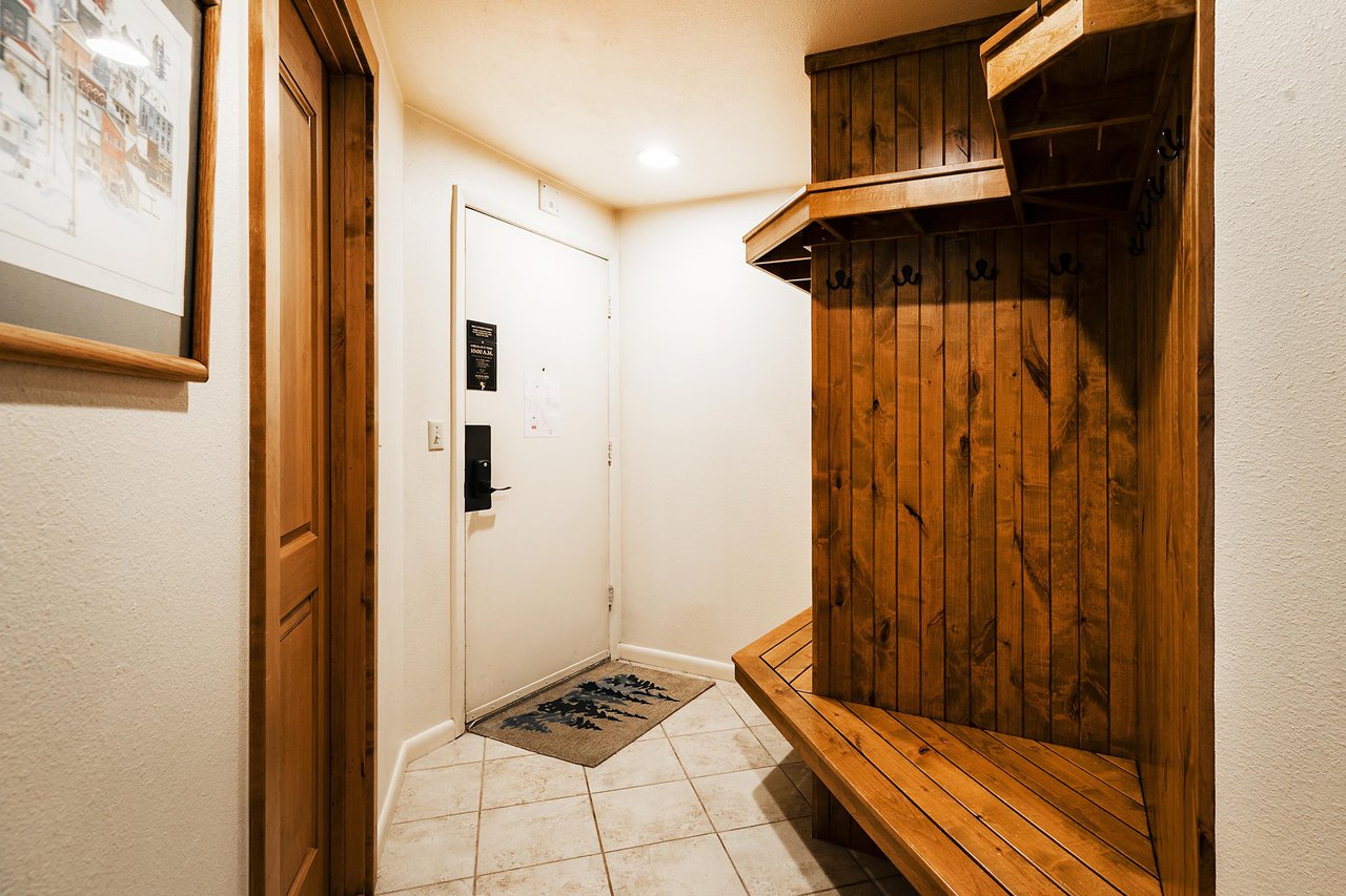 Entryway with wooden bench and racks