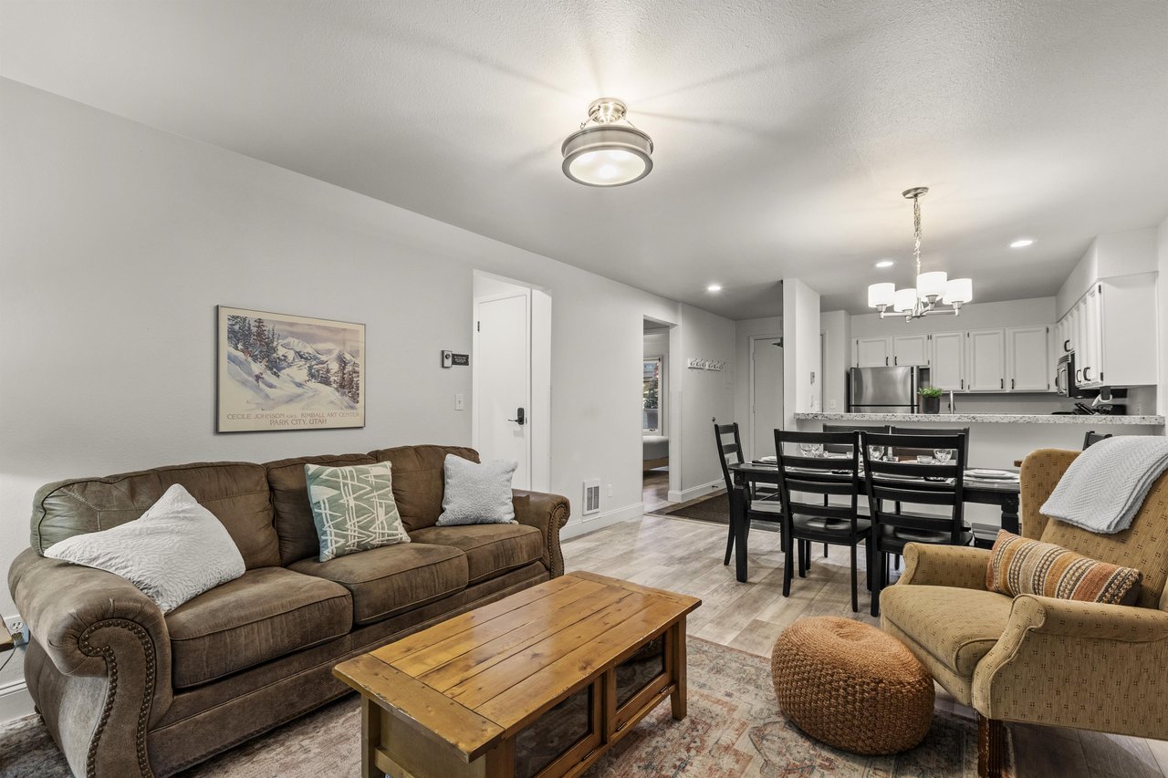 The living room offers a comfortable couch and chair.