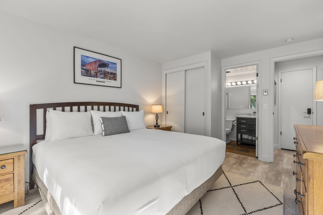 The main suite offers a king size bed and crisp white bedding.