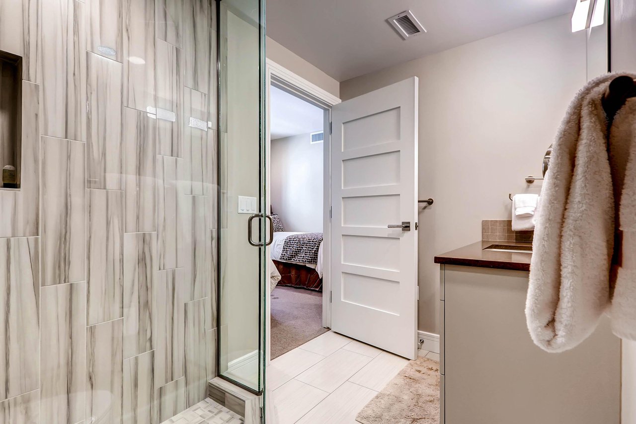 The en suite bathroom has a walkin shower with glass surround.