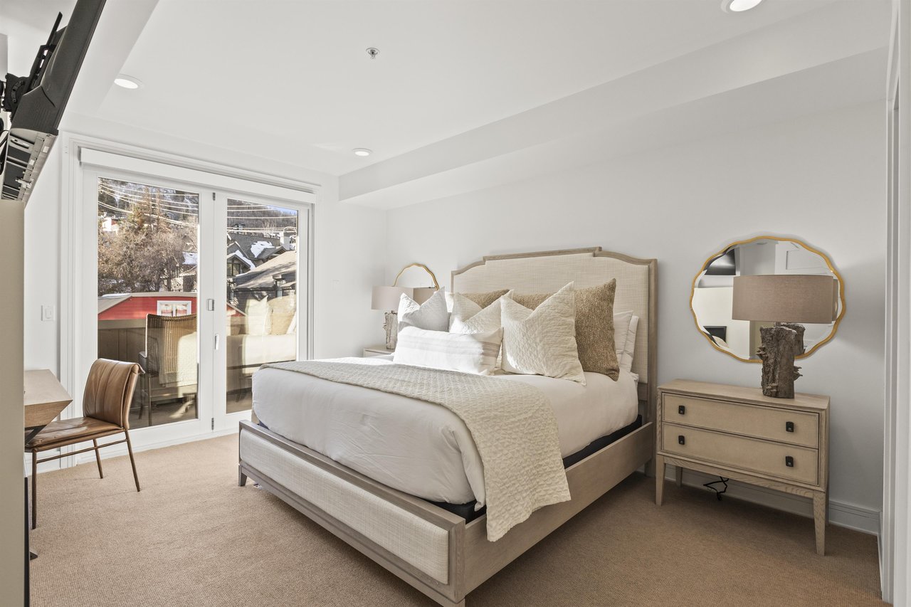 The main suite bedroom with a kingsize bed and lovely views of the town and mountains.