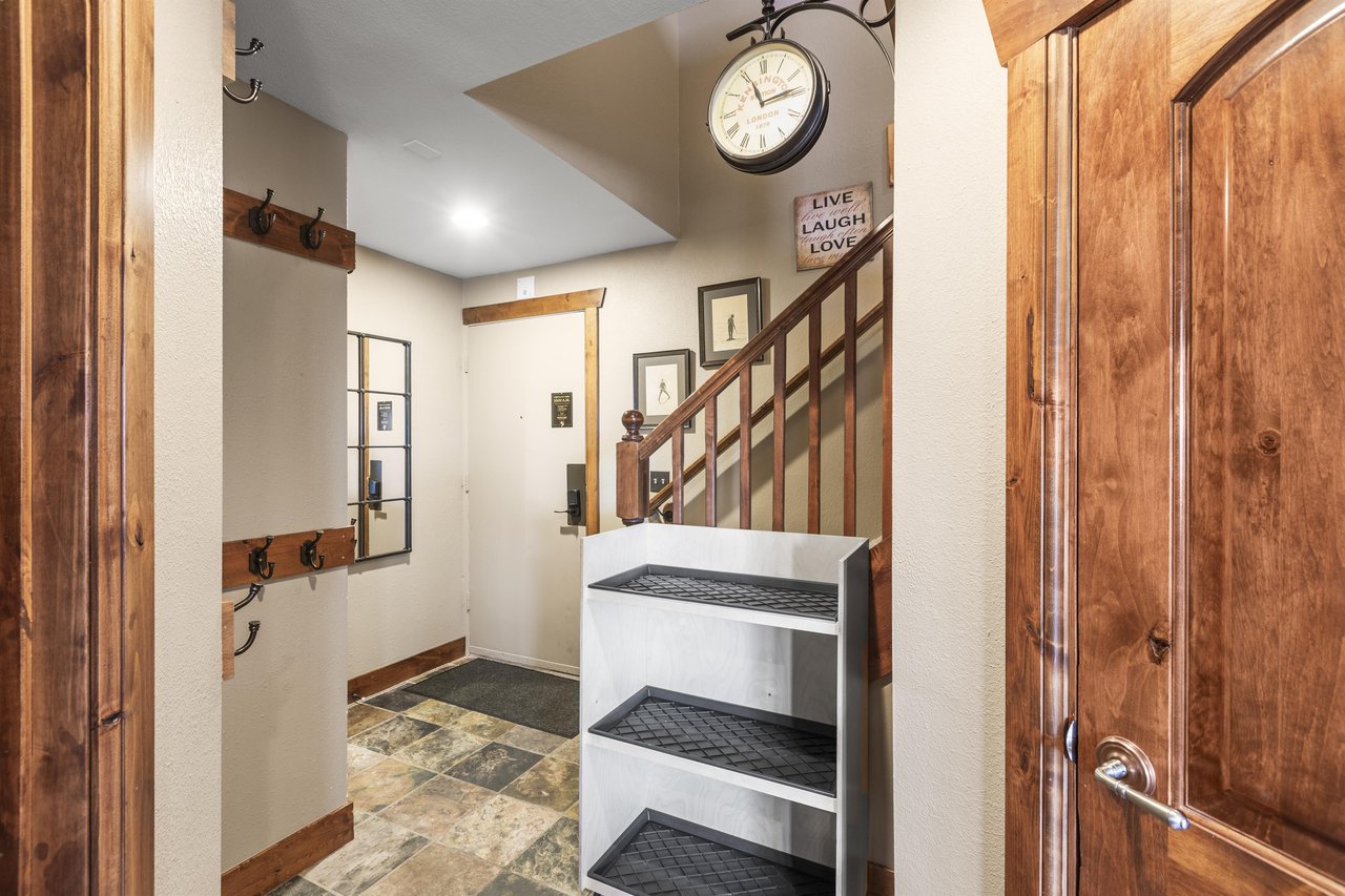 The entryway has storage for gear and plenty of hooks to hang coats.