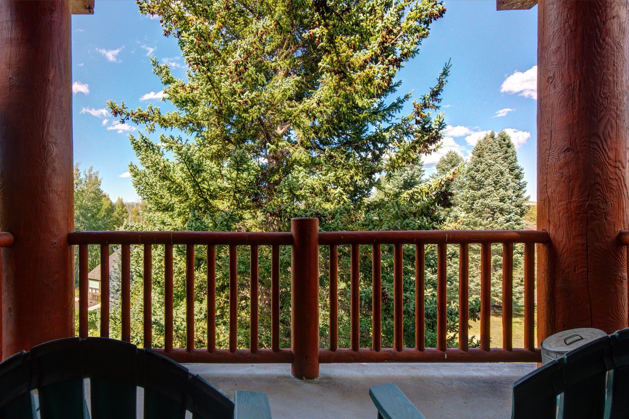 The private deck has views of the mountain and beautiful trees.